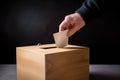 Male hand putting voting card into the ballot box on dark wooden background. Generative AI Royalty Free Stock Photo