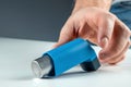 The male hand reaches for an asthma inhaler, an asthmatic attack. The concept of treatment of bronchial asthma, cough, allergies, Royalty Free Stock Photo