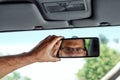 Male hand on the rearview mirror of a car, close-up. Manual adjustment of a rear-view mirror Royalty Free Stock Photo