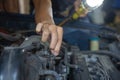 Male hand repairing car engine. Mechanic man checking car automobile engine Royalty Free Stock Photo
