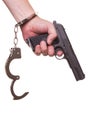 Male hand robber in handcuffs with a gun isolated on a white background Royalty Free Stock Photo