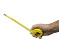 A male hand with a rollable tape measure