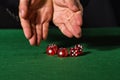 Male hand rolling five dice Royalty Free Stock Photo