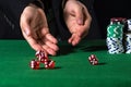 Male hand rolling five dice Royalty Free Stock Photo