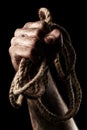 Male hand with rope. Conception aggression Royalty Free Stock Photo