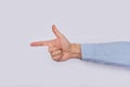 Male hand shows direction of index finger. Pointing hand close up on white background Royalty Free Stock Photo