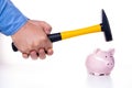 Male hand smashes a pink pig piggy bank with a hammer on a white background. The concept of savings and savings Royalty Free Stock Photo
