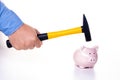 Male hand smashes a pink pig piggy bank with a hammer on a white background. The concept of savings and savings Royalty Free Stock Photo