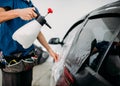 Male hand with spray, car window tint installation Royalty Free Stock Photo