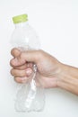 Male hand squeeze plastic bottle Royalty Free Stock Photo