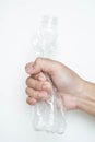 Male hand squeeze plastic bottle Royalty Free Stock Photo