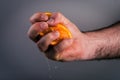 Male hand squeezing orange. Royalty Free Stock Photo