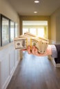 Male Hand With Stack of Cash Inside Hallway of House