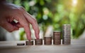 Male hand stack coins same stair for the first step like growing for the future, education, home, loan and child Royalty Free Stock Photo