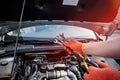 Male hand with steel wrenches on car engine