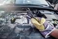 Male hand with steel wrenches on car engine