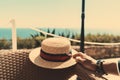 A male hand and a straw hat, beach Royalty Free Stock Photo