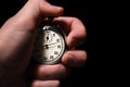 Male hand starts the analog stopwatch on a black background, close-up, isolate, copy space Royalty Free Stock Photo