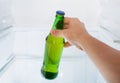 Male hand takes a bottle of beer in the fridge Royalty Free Stock Photo