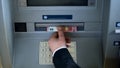 Male hand taking euros from ATM top view, withdrawing cash, business trip