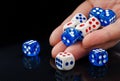 The male hand throwing dices on dark background