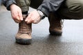 Male hand tie shoelaces on brown shoes closeup Royalty Free Stock Photo