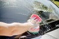 Male hand with tool for washing windows, car wash.man washing a soapy blue car with colorful sponge.Man washing car with Royalty Free Stock Photo
