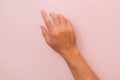 Male hand touching with one finger  on pink background. Hands to operate the touch panel Royalty Free Stock Photo