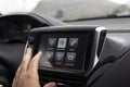 male hand touching screen in modern car