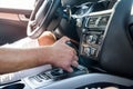 Male hand on transmission gear inside car. Close view of male hand with car interior Royalty Free Stock Photo