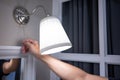 Male hand turn off the light on wall lamp Royalty Free Stock Photo