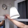 Male hand turn off the light on wall lamp Royalty Free Stock Photo