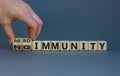 Male hand turns a cube and changes the expression `no immunity` to `herd immunity`. Beautiful grey background, copy space. Med
