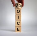 Male hand turns a cube and changes the word `voice` to `choice`. Business concept. Beautiful white background