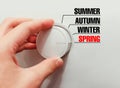 Male hand turns the switch. Switches seasons. Chose the spring. Royalty Free Stock Photo