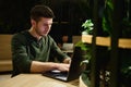 Male hand typing on laptop keyboard in cafe Royalty Free Stock Photo