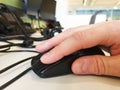 A male hand using a computer mouse