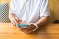 Male Hand using Digital Wireless Smart Phone on Table as Modern Royalty Free Stock Photo