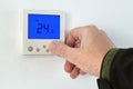 Male hand using of home heating and cooling system control unit Royalty Free Stock Photo