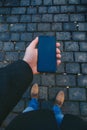 Male hand using smart phone on the street. Concept of technology and social network. Business man with watches, coat and take a ph Royalty Free Stock Photo