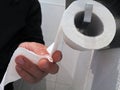 male hand using toilet paper, close up Royalty Free Stock Photo