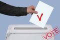 Male hand of a voter lowers the ballot in a transparent ballot box on the background, concept of state elections, referendum Royalty Free Stock Photo