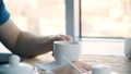 Male hand and white cup. Man holding blank cup, closeup. Closeup portrait of a young handsome man having a cup of coffee