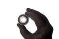 Male hand in work glove holding metal roller bearing. Ball bearing isolated. Super Precision Ball Bearings used in high