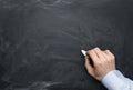 Male hand writing on a blackboard Royalty Free Stock Photo