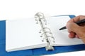 Male hand writing at blue leather notebook Royalty Free Stock Photo
