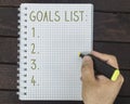 Male hand is writing goals list on a notepad Royalty Free Stock Photo