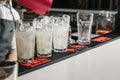 Male hands of the bartender close-up, makes a cocktail on the bar, glasses with ice Royalty Free Stock Photo