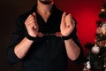 male hands in BDSM handcuffs for submission and domination against the background of a Christmas tree on New Year& x27;s Royalty Free Stock Photo
