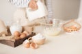 Male hands beating egg whites cream with mixer in the bowl